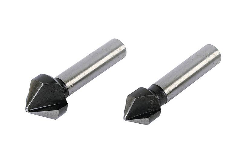 Two centre drills with conical metal tips are lying parallel to each other.