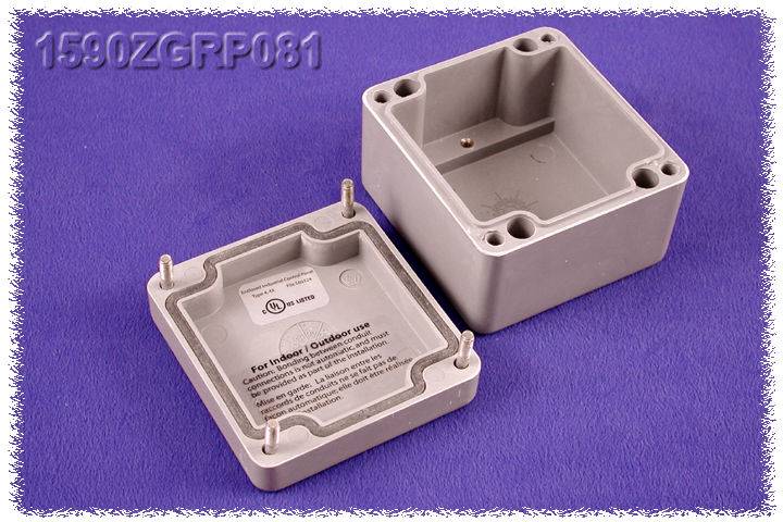Electronic enclosures: grey plastic boxes with screws. One opened, showing interior view. Label provides internal usage instructions.