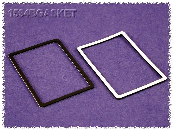 Two rectangular seals, one black and one white, are lying side by side on a lilac surface. Above them is written '1594BGASKET'.