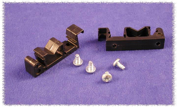 Two black mounting brackets and three silver screws on a lilac base. Components for a technical assembly.