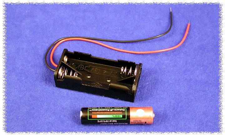 Battery holder for two AA batteries with red and black wires, alongside a single AA battery on a blue background.