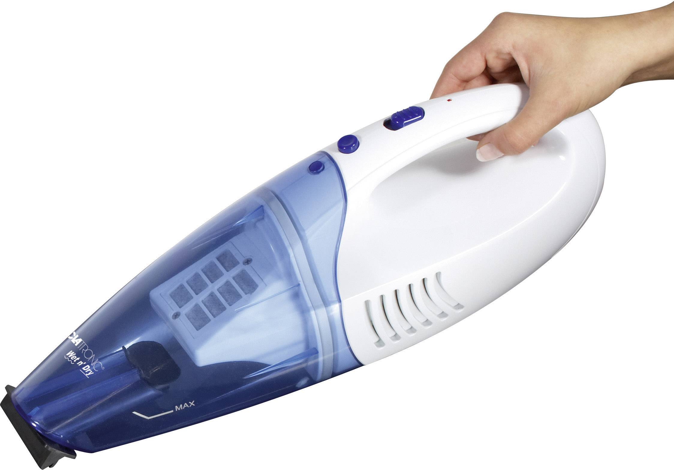 A person is holding a blue and white handheld vacuum cleaner. The device is showing its maximum fill level.