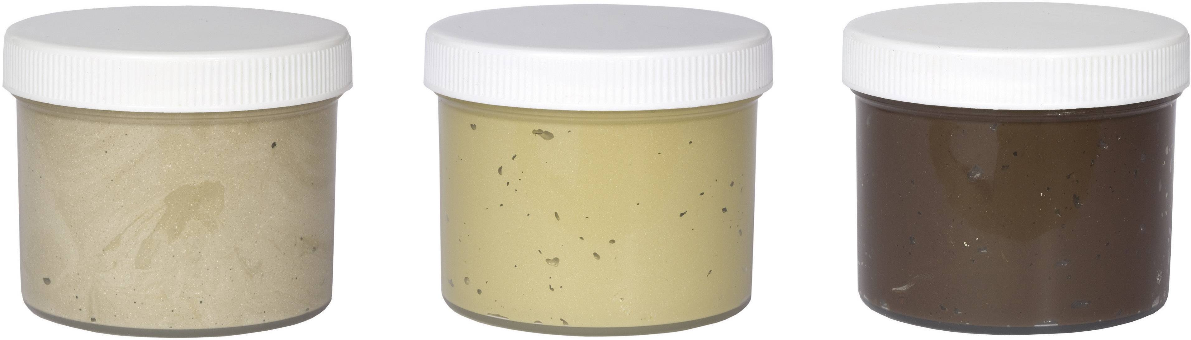Three jars with screw-top lids, filled from left to right with beige, yellow, and brown paste.