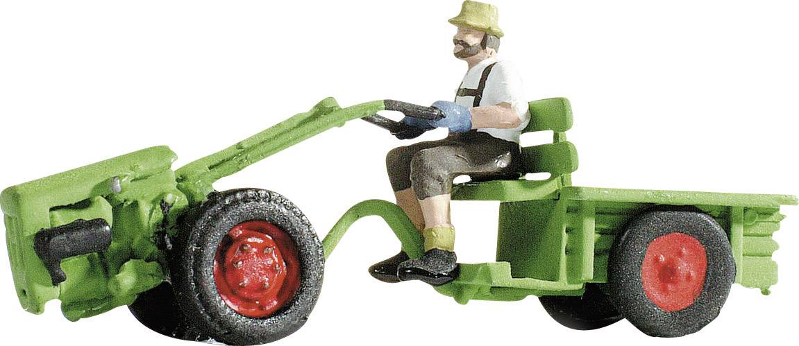 A model of a man on a small tractor in green and red. The man is wearing a hat, gloves, and brown trousers.