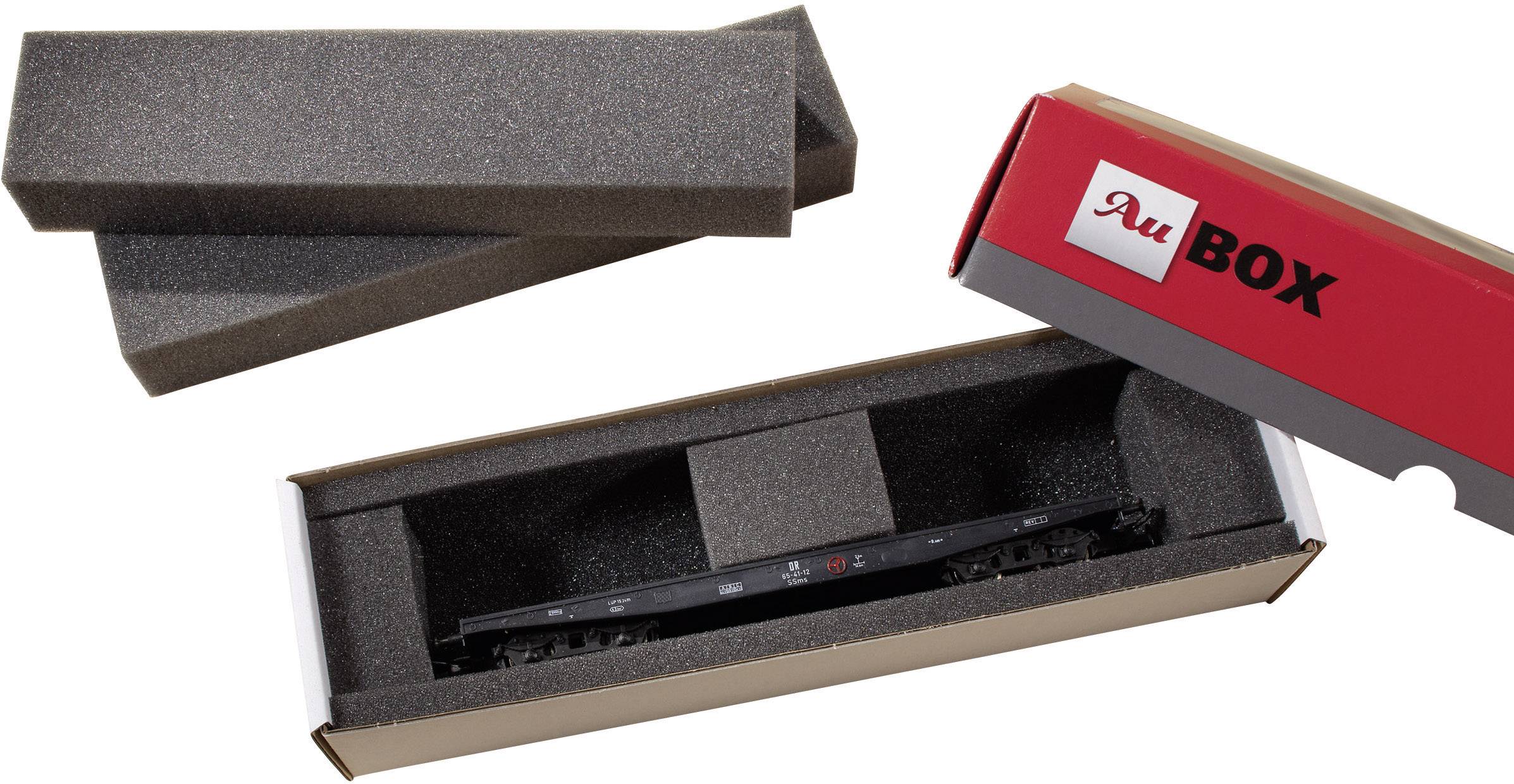 Packaged model railway accessory in foam lining, surrounded by an opened red cardboard box with the inscription 'BOX'.