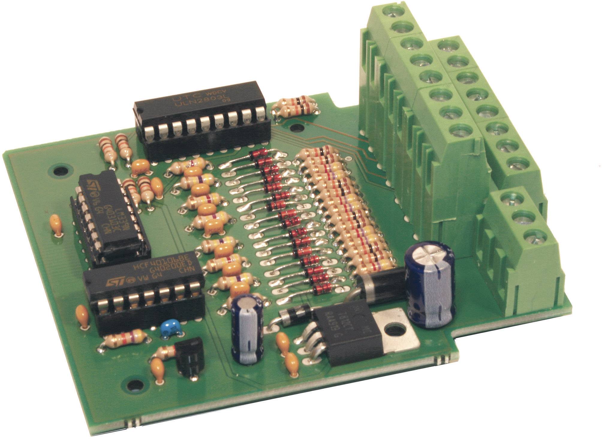 A green printed circuit board with various electrical components such as resistors, capacitors, and integrated circuits.