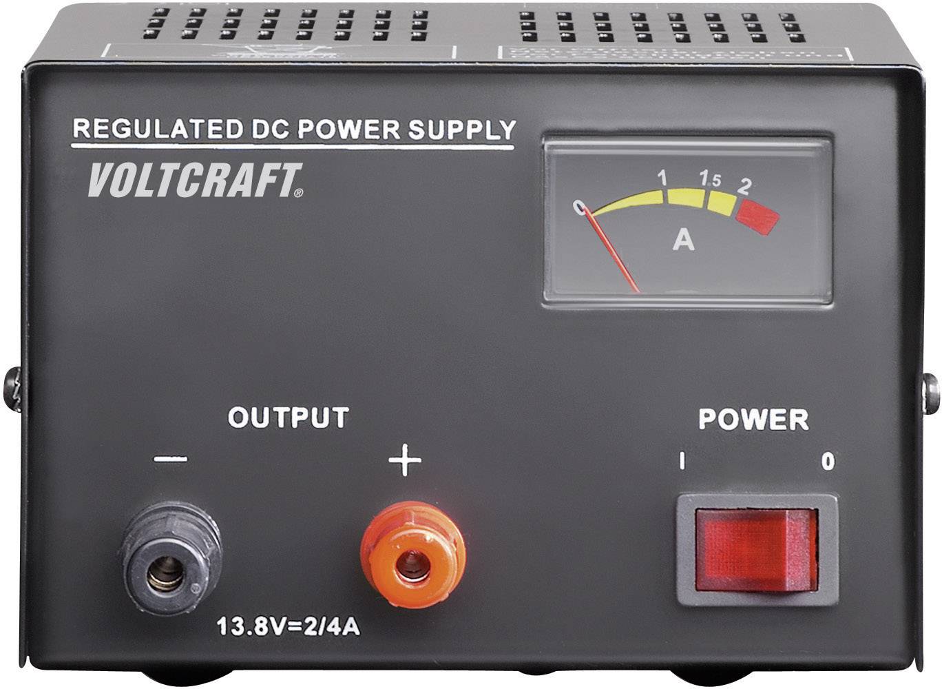 The image shows a Voltcraft adjustable DC power supply with an ammeter, output connections, and a power switch.
