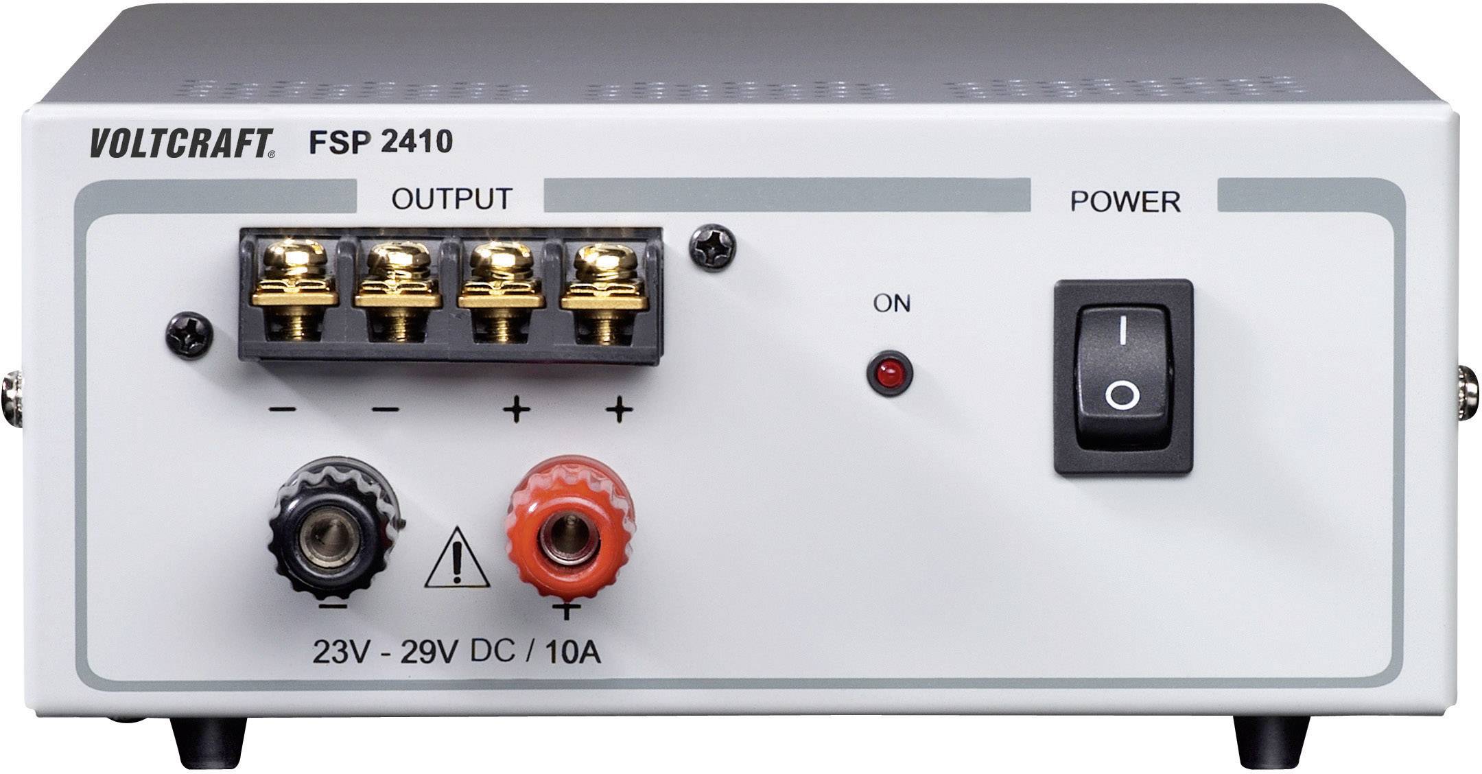 A Voltcraft power supply unit, model FSP 2410, with an adjustable DC output from 23V to 29V and a maximum current of 10A. Power switch located on the right.