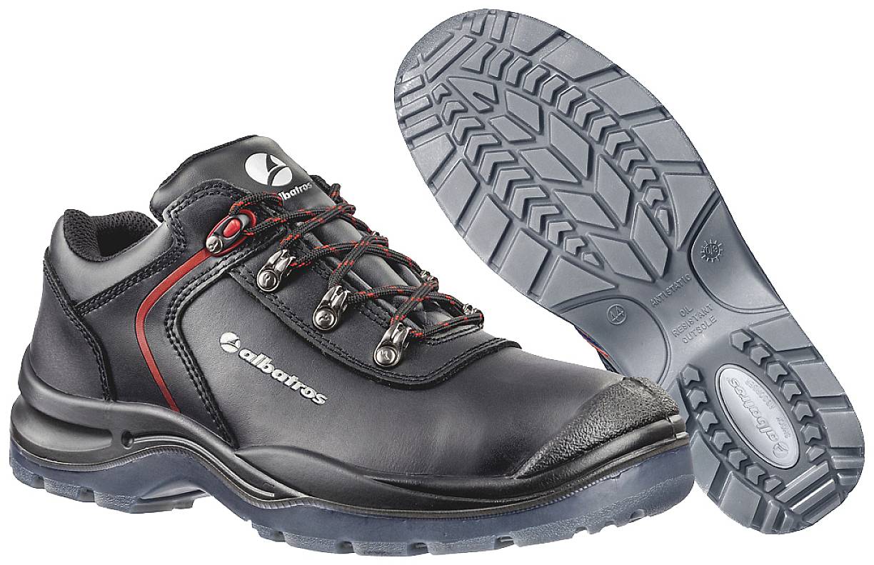 A pair of black safety shoes with red accents, robust sole tread, and laces, suitable for outdoor work.