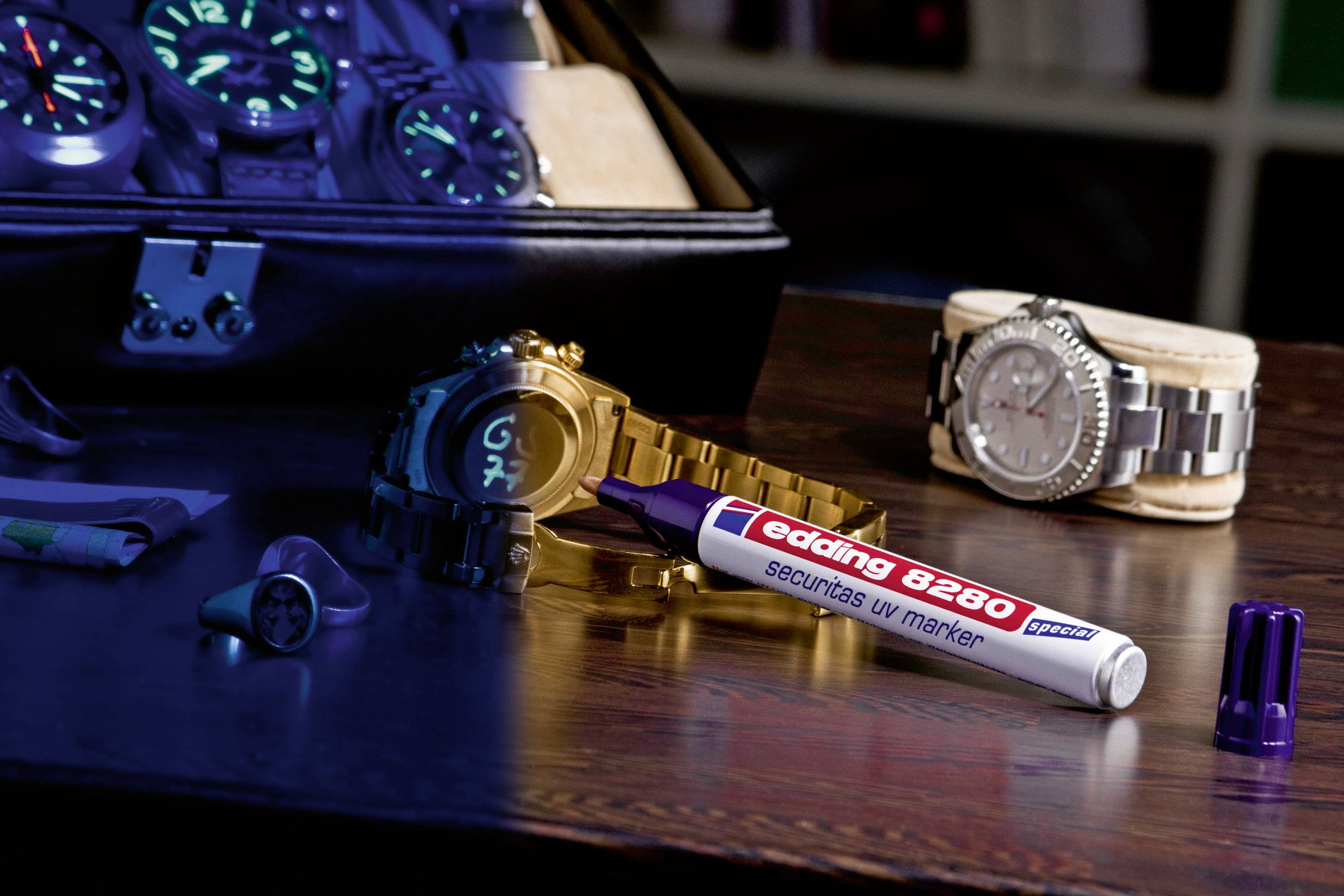 A UV marker lies on a table near wristwatches. The left half of the image is blue-lit and shows glowing markings.
