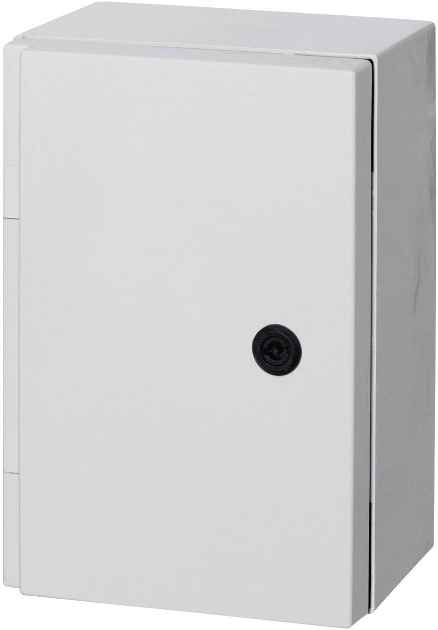 A rectangular white fuse box with a black rotary lock, mounted on a wall.