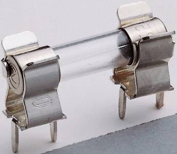 Close-up of a glass fuse with metal caps, lying on a grey surface, with two protruding terminals.
