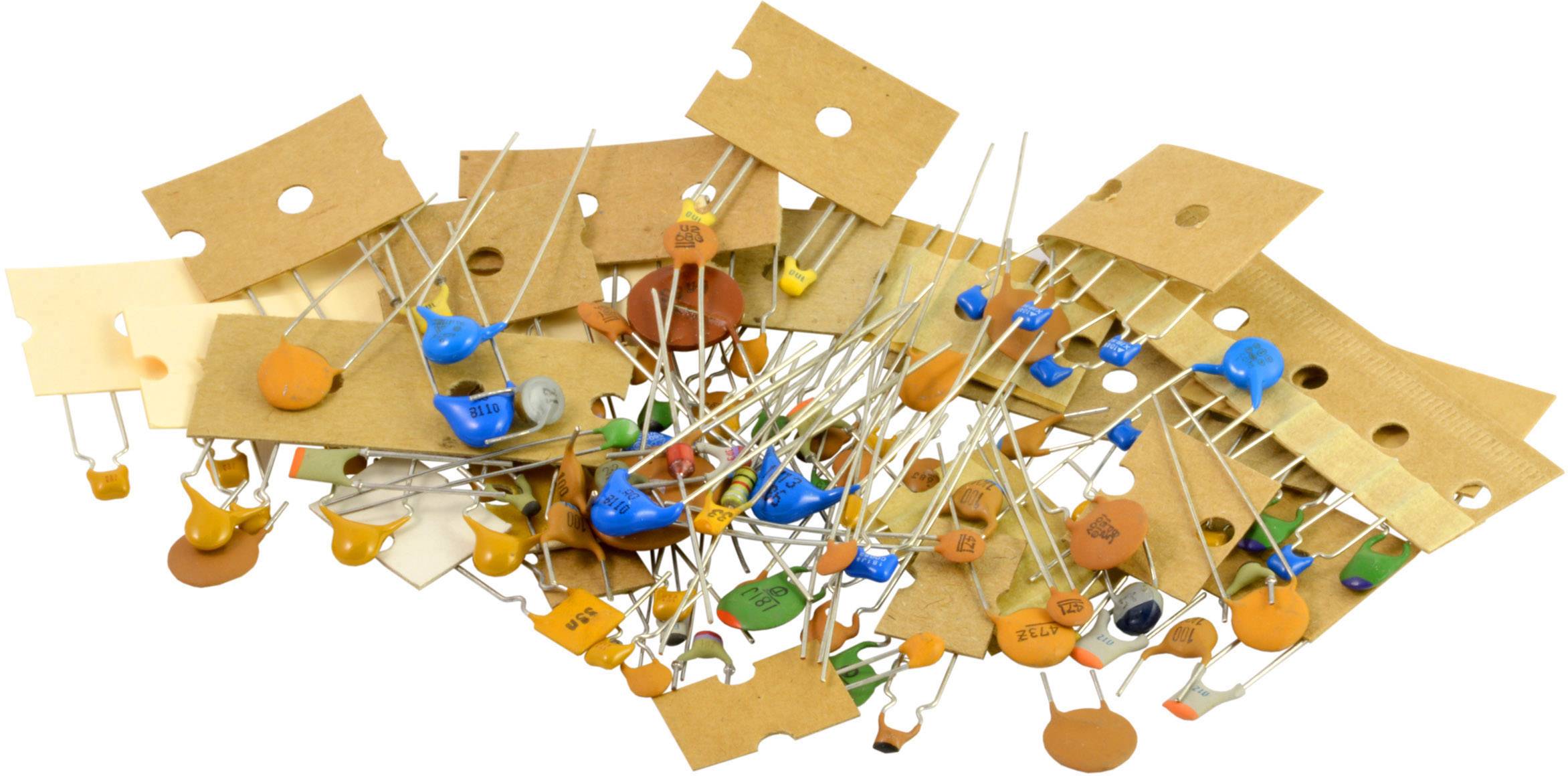 Various colourful electronic components such as capacitors and resistors, unsorted and piled together, on a white background.