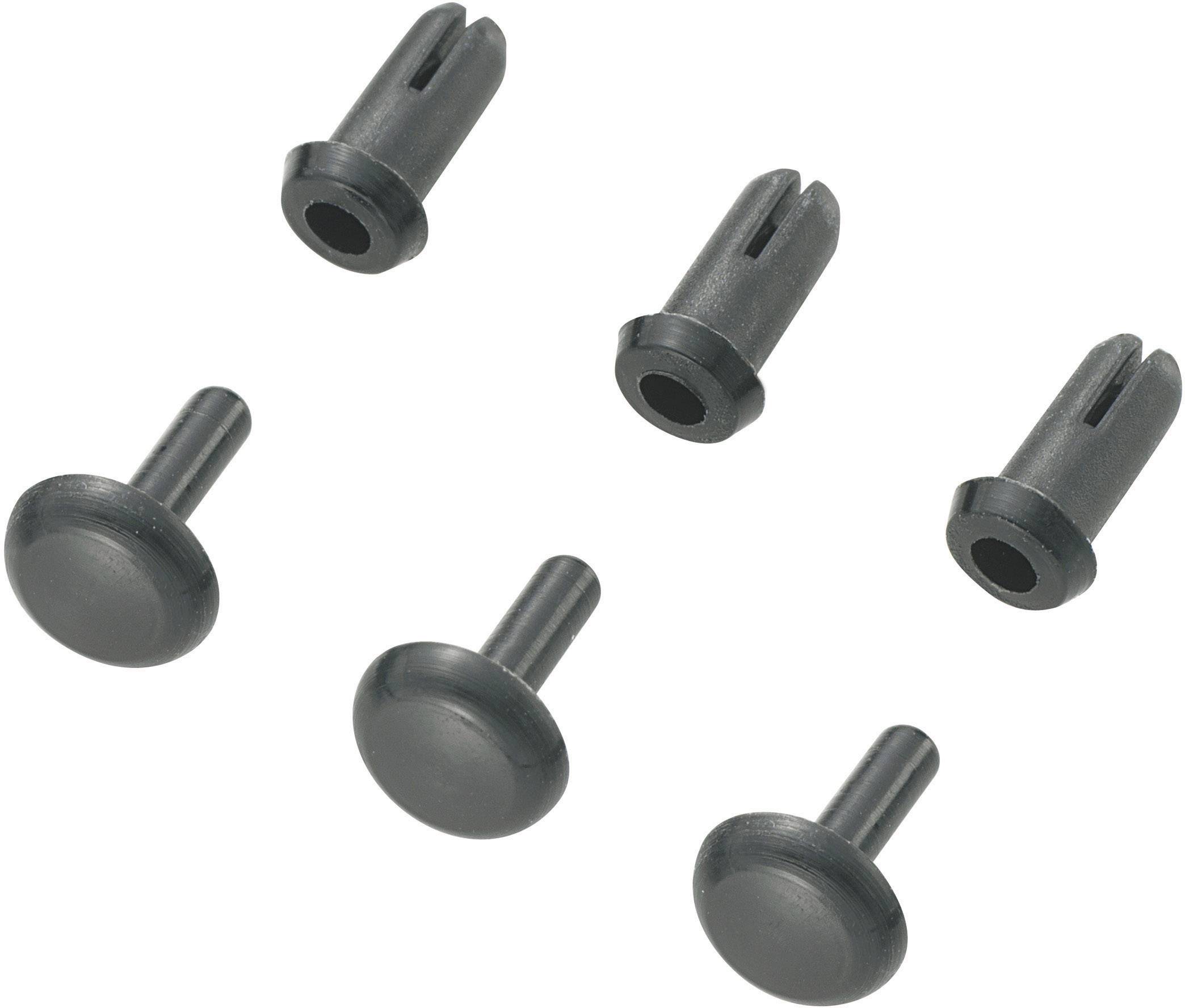 Six grey plastic wall plugs in two different designs on a white background.