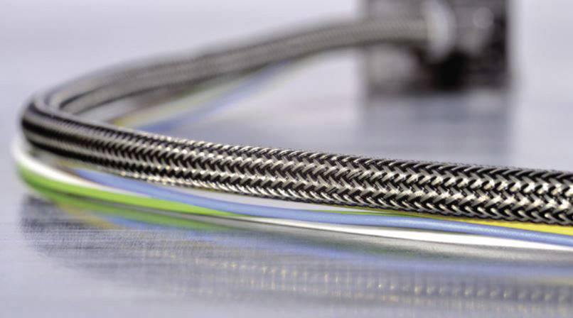 Close-up of a woven metal cable sleeve encasing multiple electrical cables. The metallic structure provides additional protection and flexibility.
