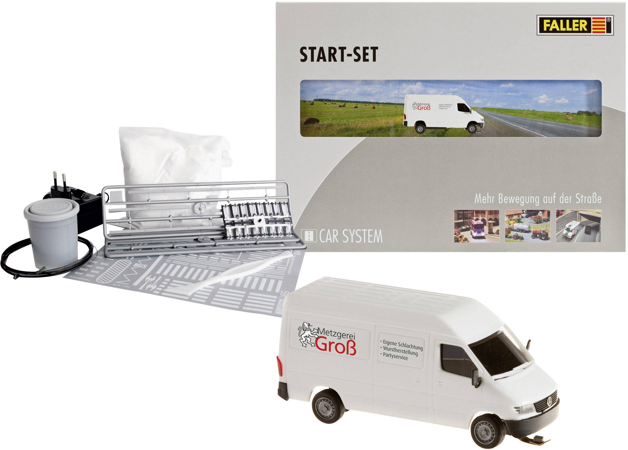 Start-up set with model vehicle bearing 'Metzgerei Groß' inscription, road system components and charger. Contains building plans and accessories.