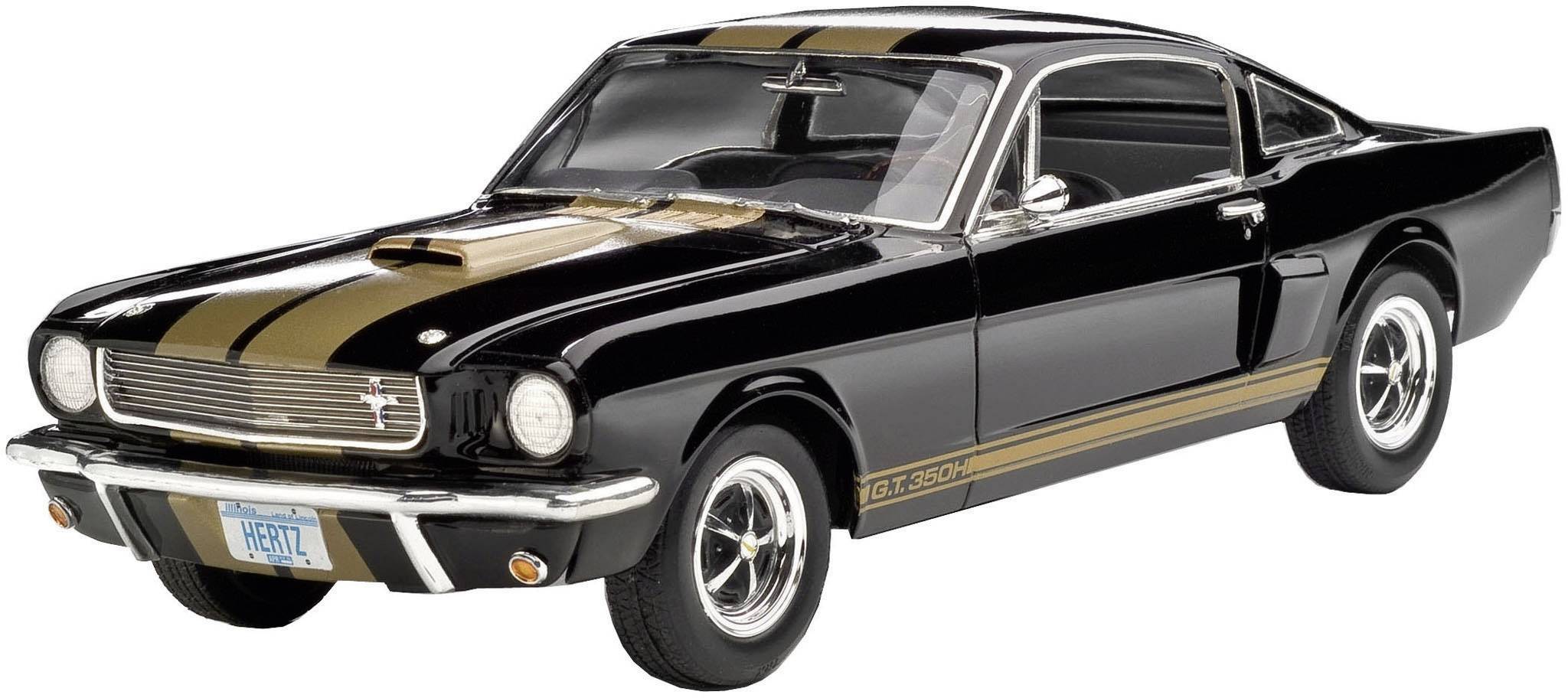 Classic black sports car with golden stripes and white tyres. The model could be a vintage car.