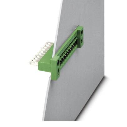 A green connector mounted on a grey, vertical plate; the pins are visible passing through the plate.