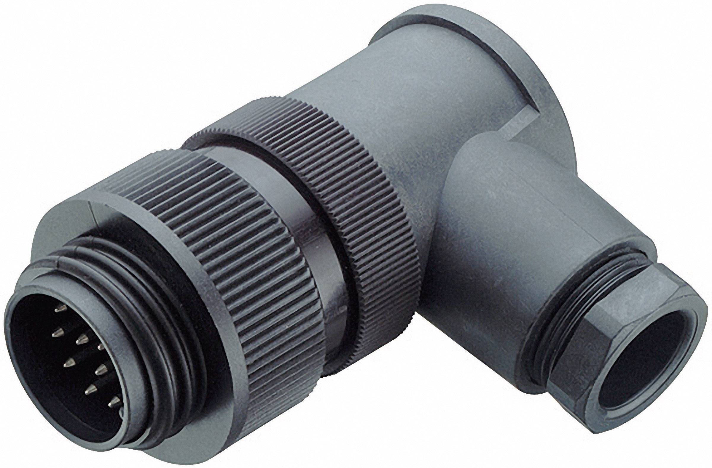 A black, angular plug with multiple metal pins, used for electrical connections, lies on a white background.