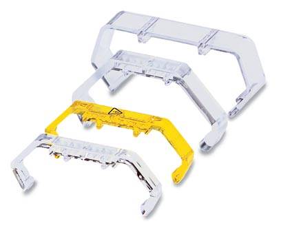 Three transparent, curved safety brackets, one yellow with a warning symbol, support laptop screens.