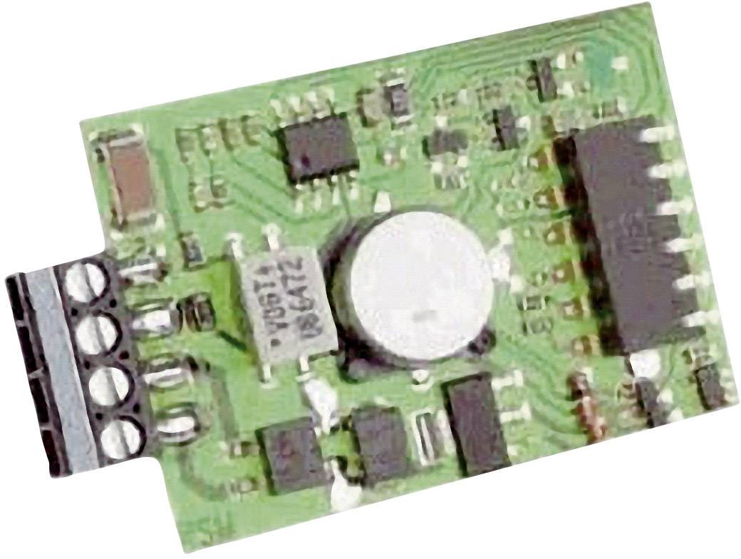 A green electronic circuit board with various chips and components, including a large white circle in the centre.