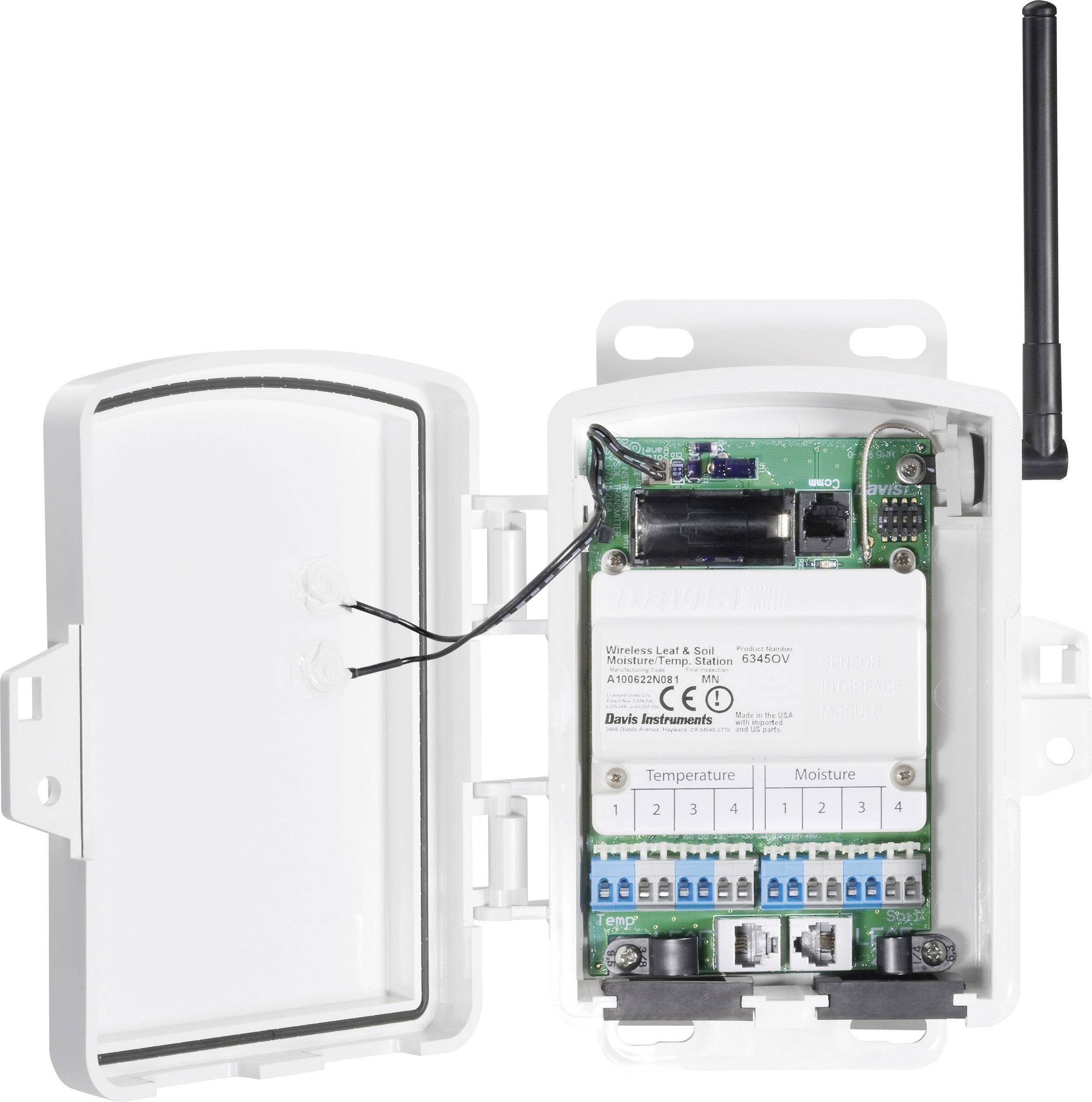 An opened electronic device with visible circuit boards and connections. An antenna is mounted in the top right corner.