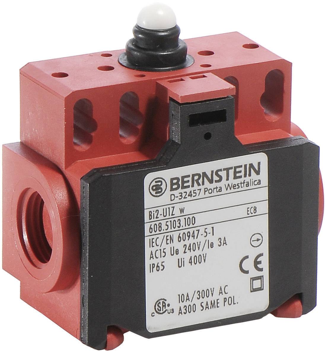 Red emergency stop switch with black housing and white button on top. Label with technical specifications such as voltage and IP65 protection rating.