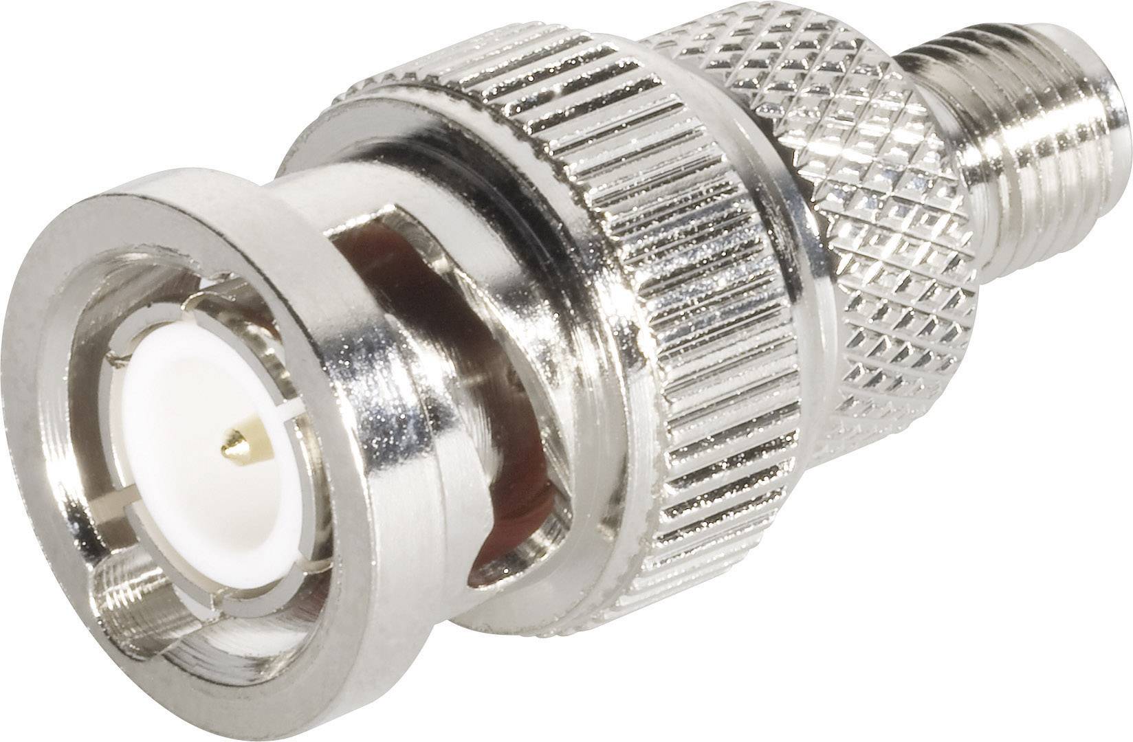 A metallic coaxial plug with a knurled grip and central pin, suitable for connection to electronic devices or cables.