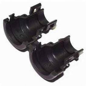 Two black, hemispherical, rigid plastic parts against a white background, fitted together or arranged in a line.