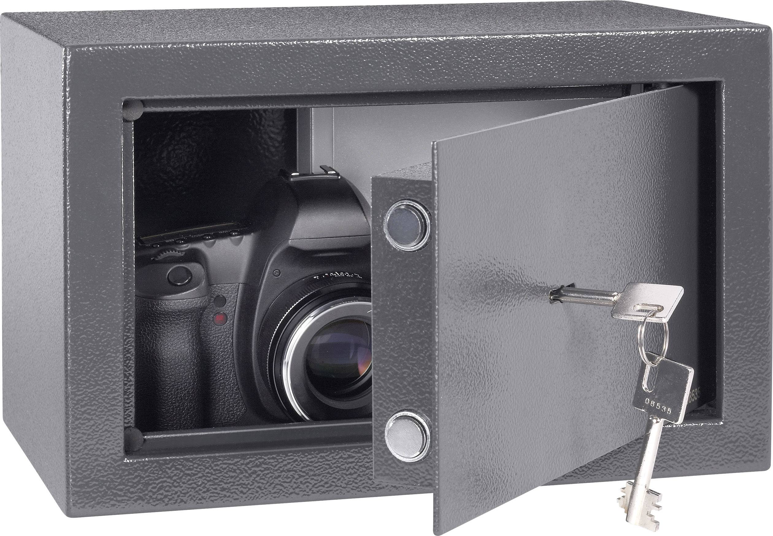 Closed safe with slightly open door, inside which a camera is visible. Two keys are inserted in the lock.
