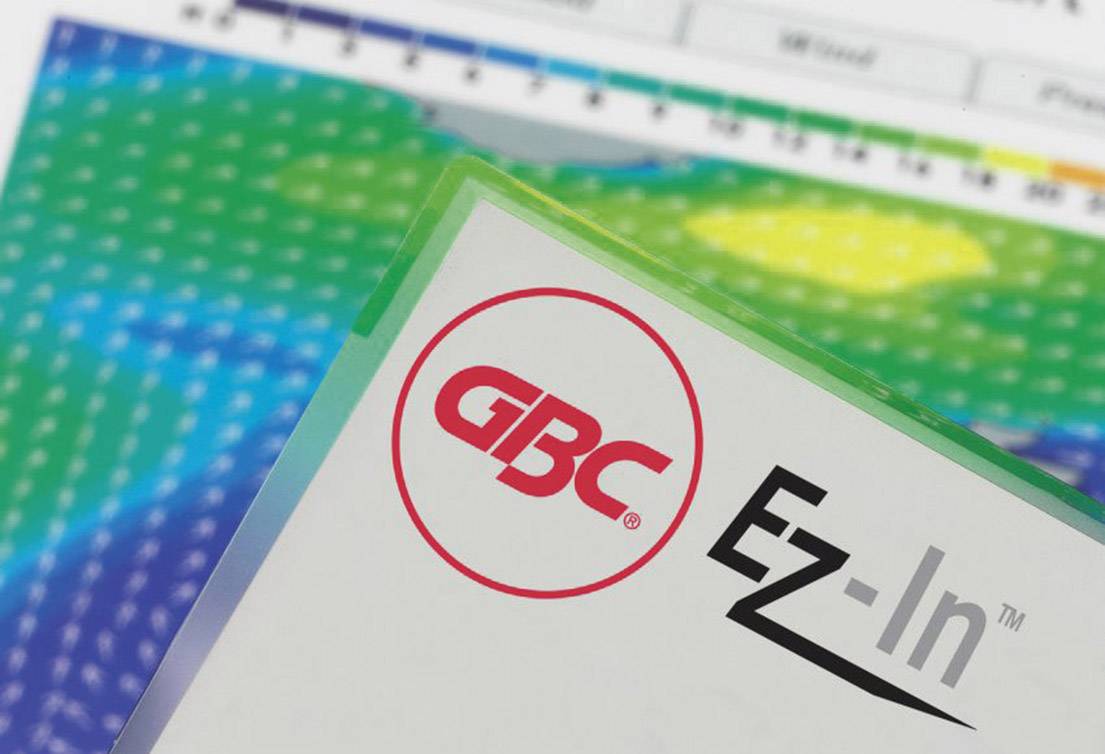 A GBC EZ-In™ laminating pouch packet lies on a colourful, blurred background, presumably a temperature chart.
