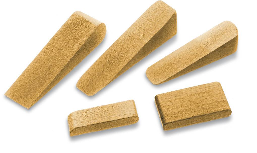 Five wooden wedges of different sizes and shapes are lying on a surface.