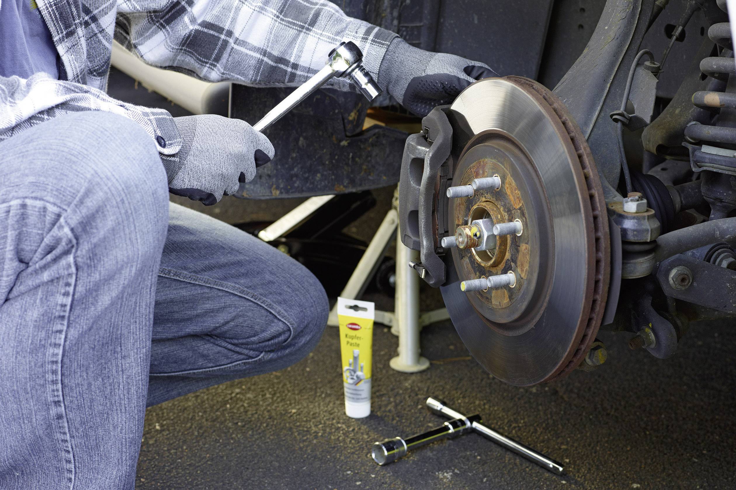 Person repairing car brakes