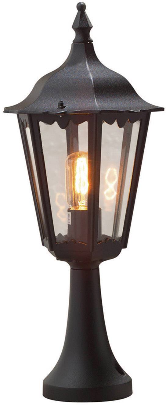 Black lantern in a classic style with transparent glass. A luminous light bulb is visible, emitting a warm light.