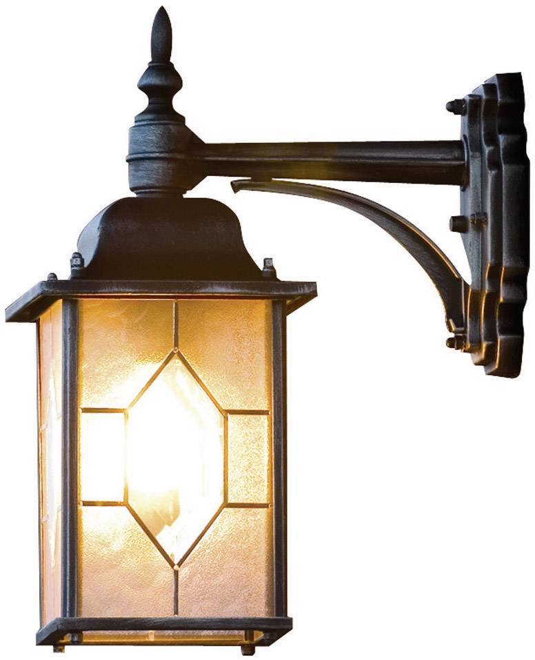 A rustic wall light made of metal and glass with warm lighting, mounted on an external wall.