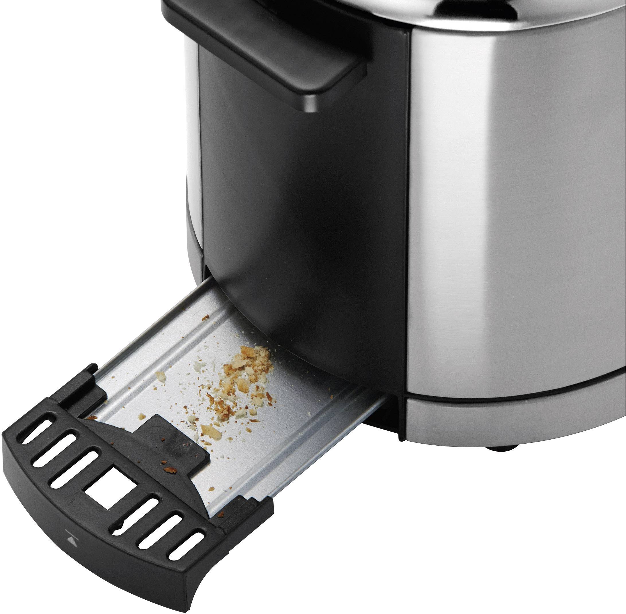 A toaster with a removable crumb tray that has collected crumbs and bread pieces. Demonstrates the cleanliness feature of the toaster.