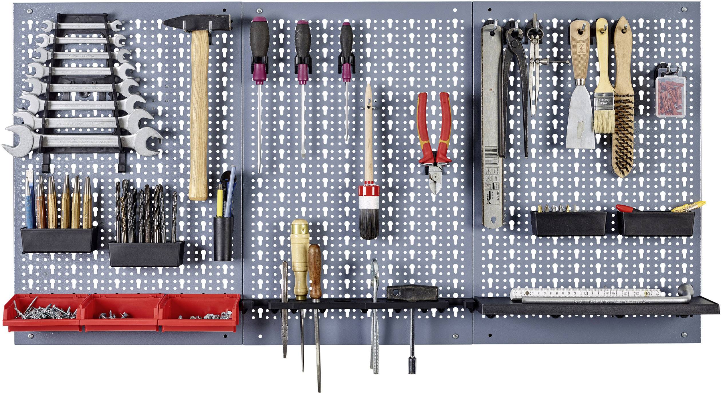 A tool wall with hammers, screwdrivers, pliers, spanners, and drill bits, neatly hung and organised.