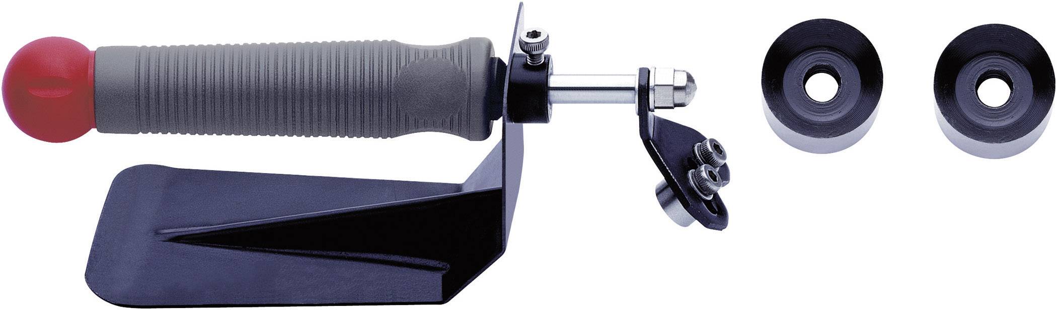 A tool with a red handle, black base and silver shaft. Next to it are two black round seals.