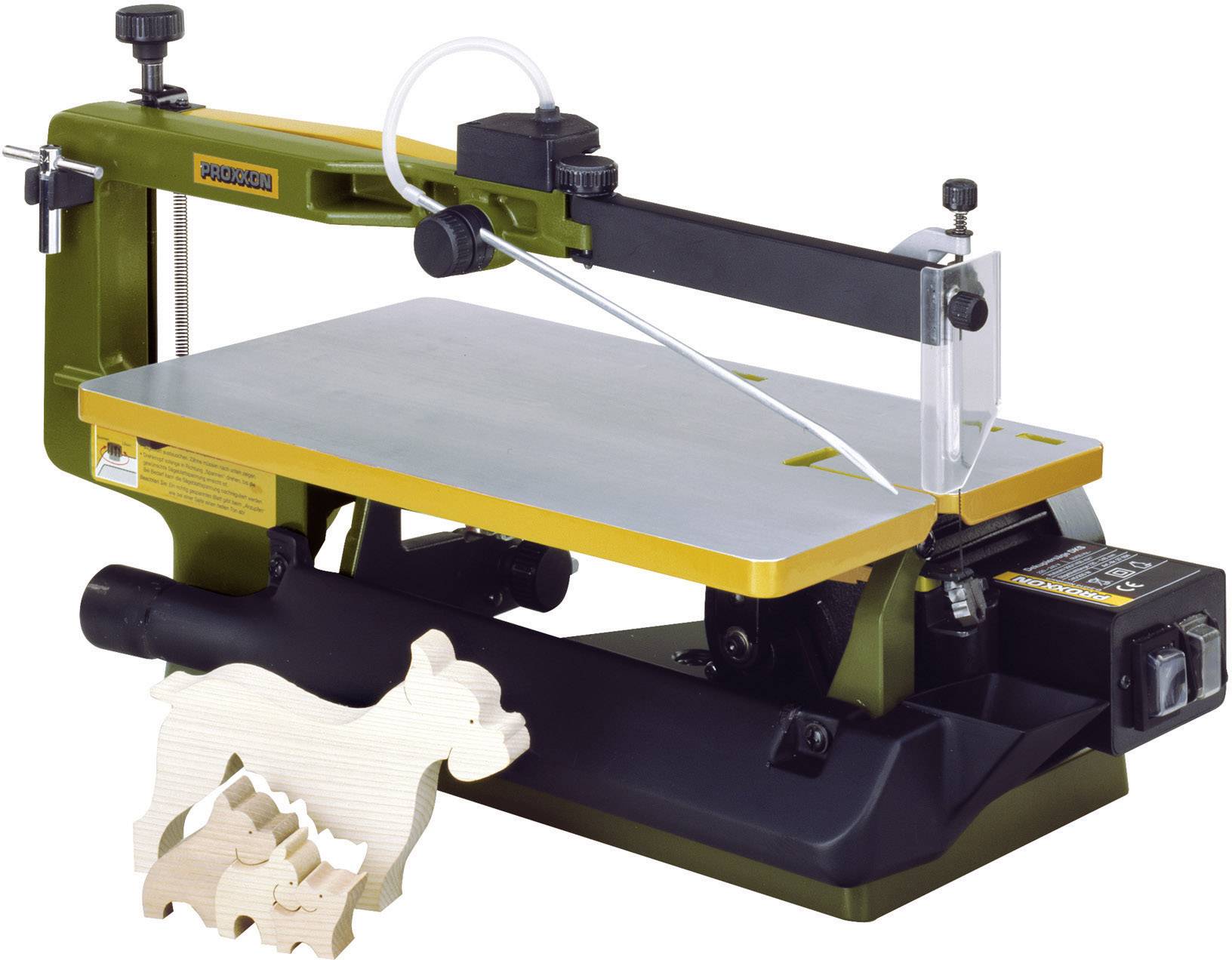 A jigsaw saw on a table with a wood-cutting project in the shape of an animal beside it shows craftsmanship.