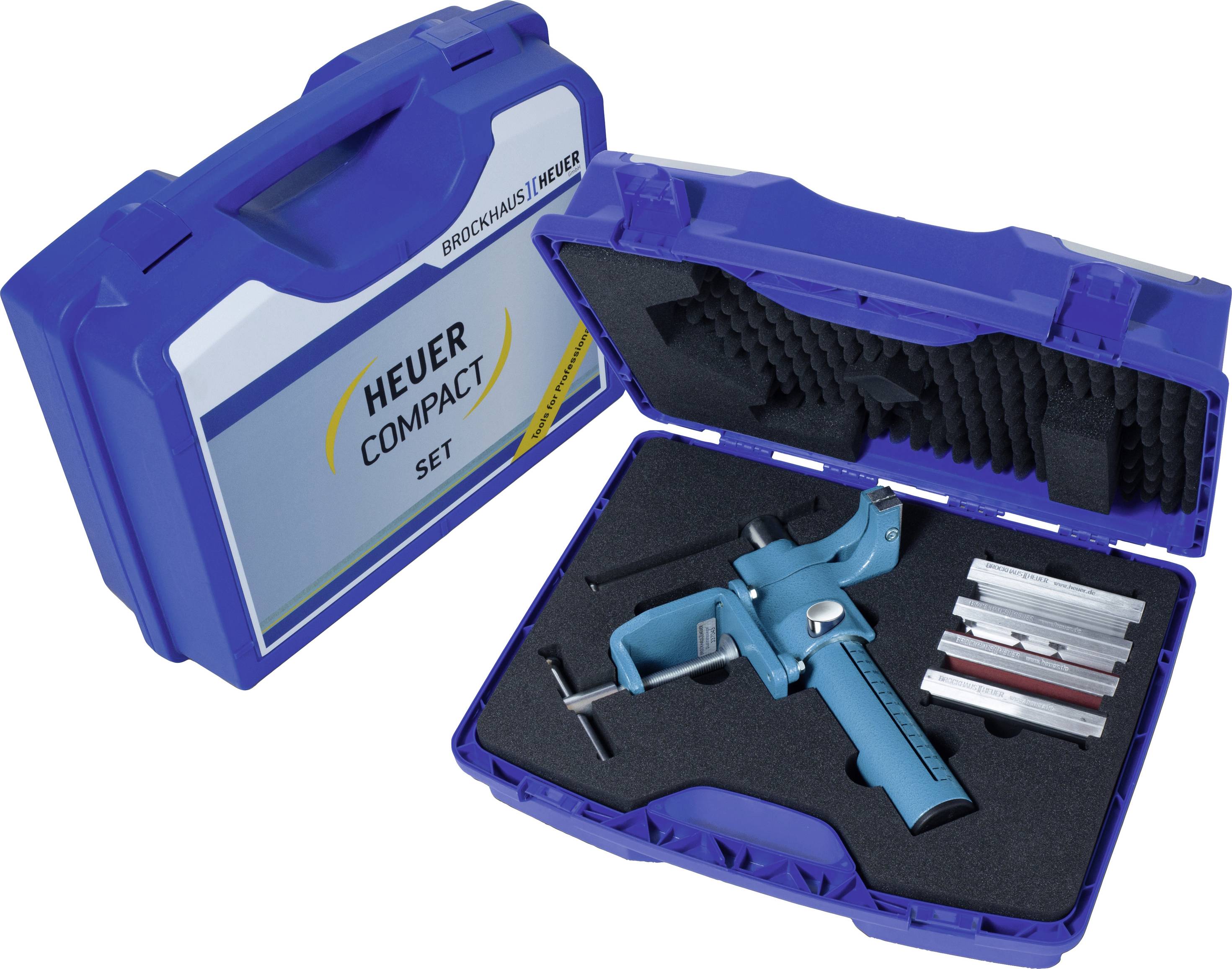 Blue case with foam lining, containing a blue toggle lever and other metal components. Text on the case: 'Heuer Compact Set'.