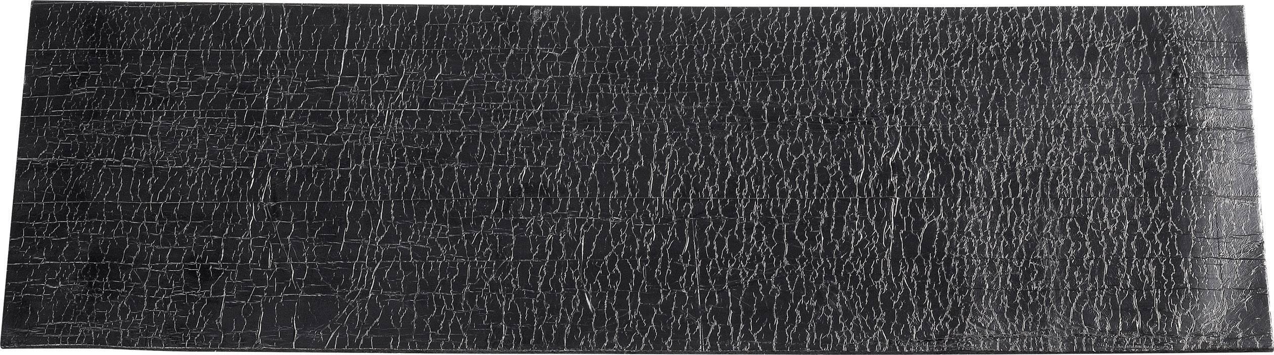 Rectangular, black block with an irregular, cracked pattern. Surface appears textured.
