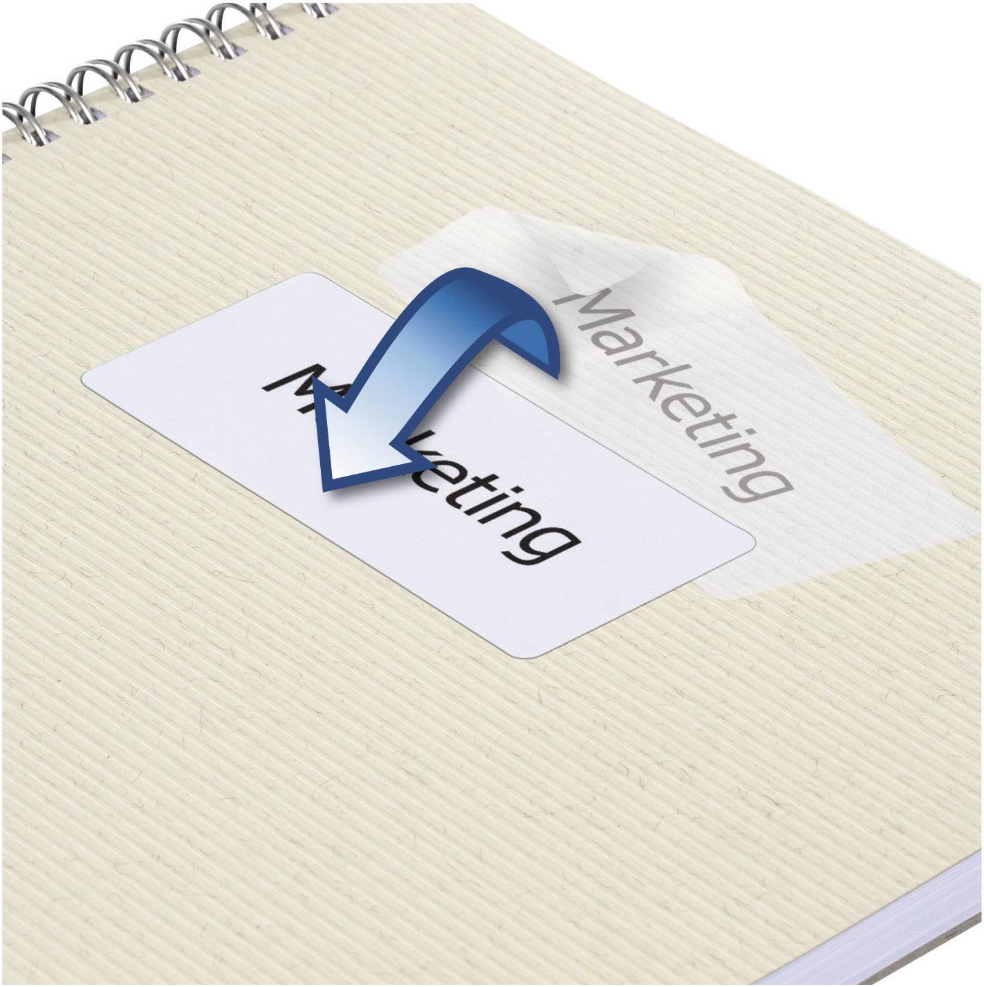 A notebook with a white label reading 'Marketing'. An arrow points to the label, suggesting a change or update.