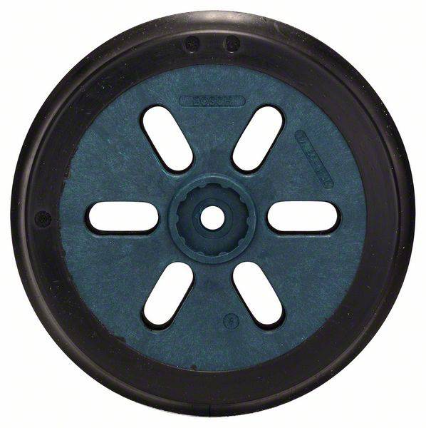 Une roue en plastique noir, ronde, avec six rayons ovales et une structure de type roue dentée au centre, sur un fond blanc.