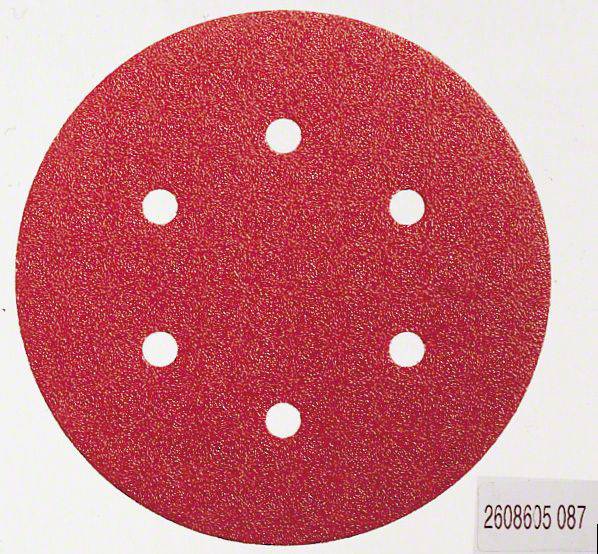 Papier de verre rond rouge avec six trous, sur fond blanc.
