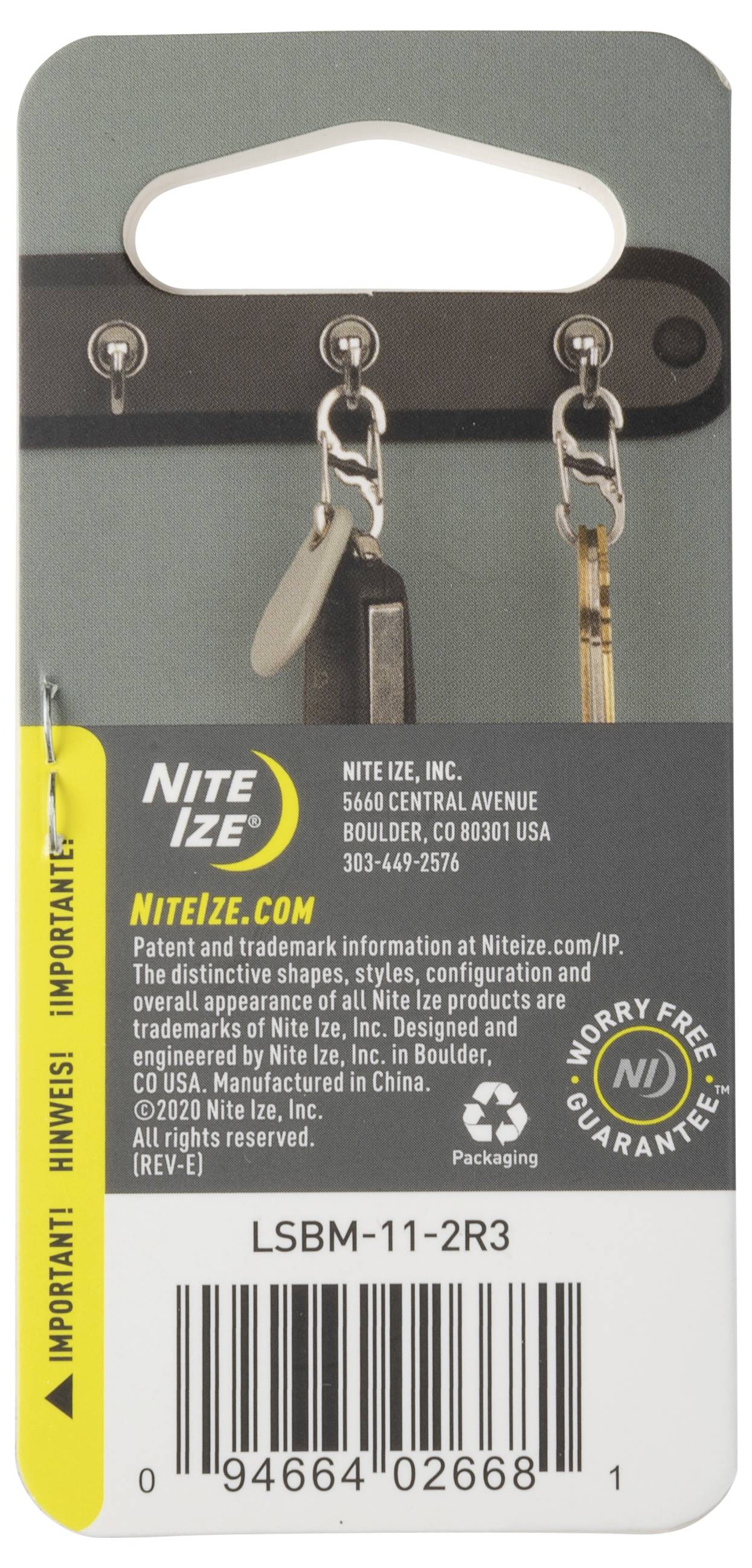 L'image montre un emballage Nite Ize pour des accessoires de clés. Il présente un crochet avec des clés et un code-barres en bas. Le texte met en évidence les garanties et les détails de l'entreprise.