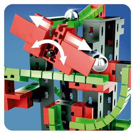 Un jouet de construction complexe avec des blocs rouges et verts montre des circuits de billes et des pièces mobiles qui influencent leur trajectoire.