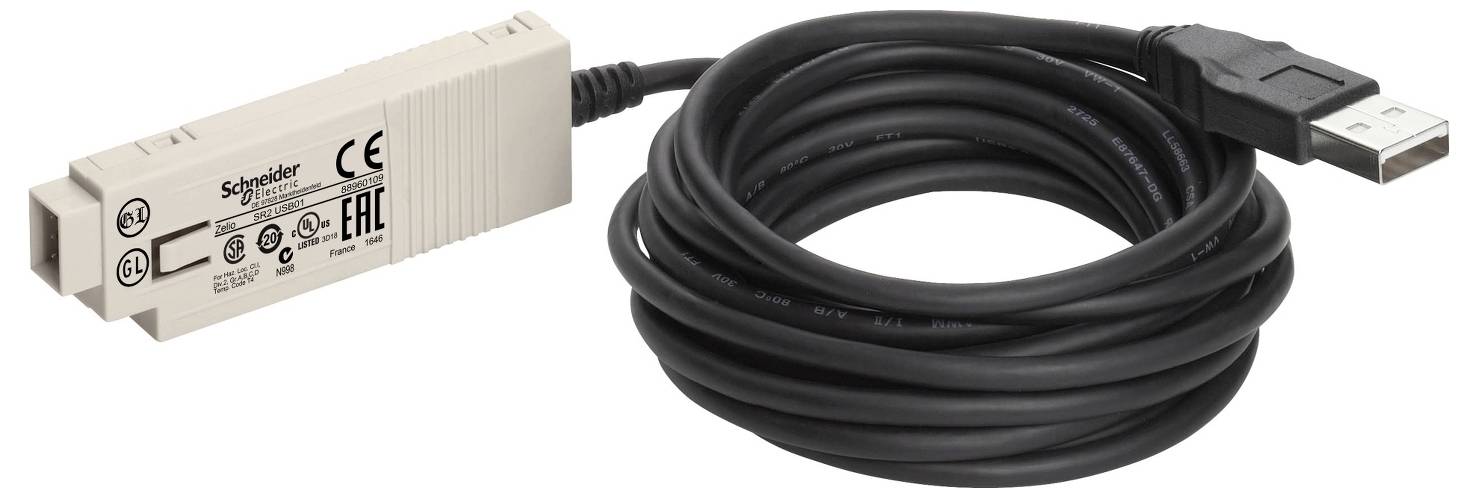 Câble adaptateur USB avec un module d'interface Schneider Electric beige et un câble USB noir enroulé, présenté sur un fond blanc.