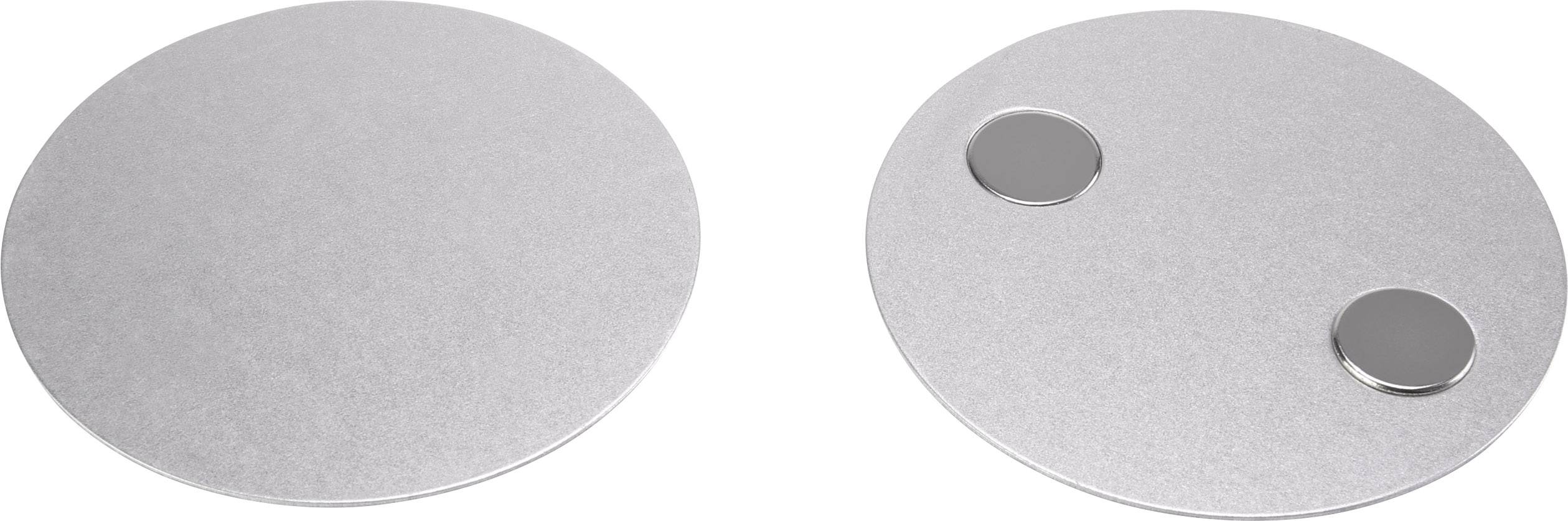 Deux objets métalliques circulaires : à gauche un disque lisse, à droite un disque avec deux petits aimants ronds.