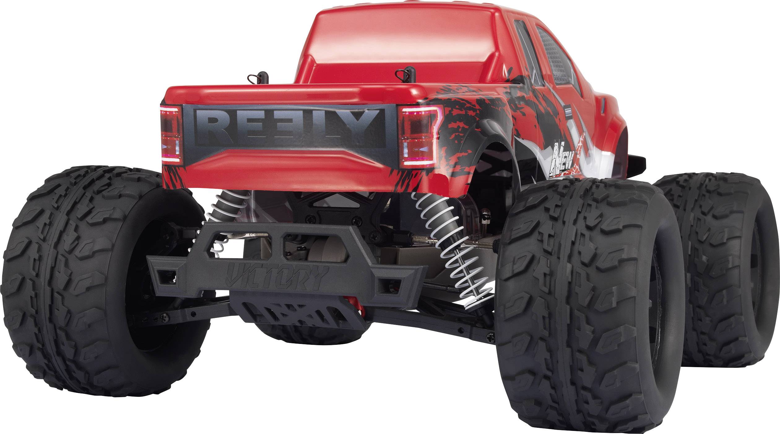 Un modèle de monster truck télécommandé rouge avec de grandes roues profilées, des amortisseurs visibles et l'inscription 'Reely'.