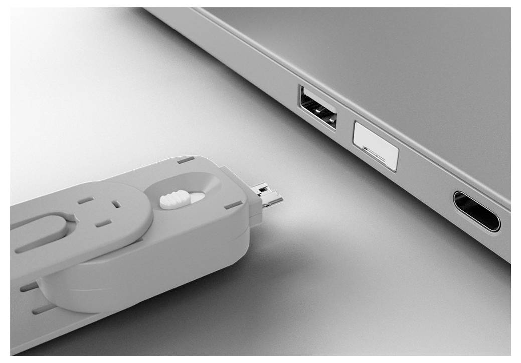 Une clé USB qui est insérée dans le port USB d'un ordinateur portable, avec les ports HDMI et autres ports latéraux visibles à proximité.